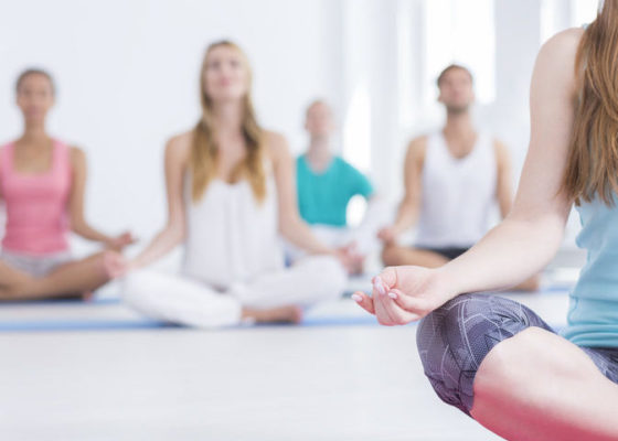 Imagine your happy place Cropped shot of people doing yoga in a studio