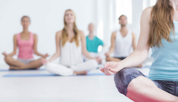 Cropped shot of people doing yoga in a studio